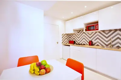a bowl of fruit on a white table in a kitchen at Emma Apartment Central in Valencia