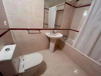 a bathroom with a white toilet and a sink at NEW! Apartamento Ciudad de las Artes in Valencia