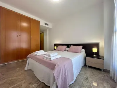 a bedroom with a bed with two towels on it at NEW! Apartamento Ciudad de las Artes in Valencia