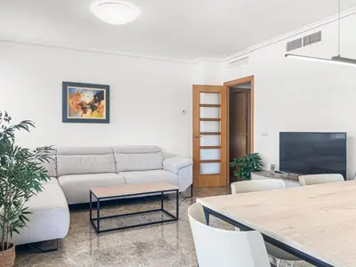 a living room with a couch and a table at NEW! Apartamento Ciudad de las Artes in Valencia