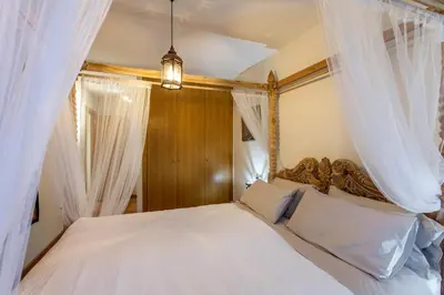 a bedroom with a large bed with white curtains at LUXURIOUS & ALLURING HOME IN HISTORIC TOWN (VALENCIA) in Valencia