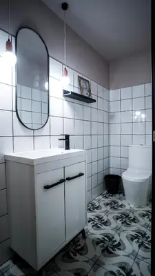 a bathroom with a sink and a mirror and a toilet at Hografic Hotel in Valencia