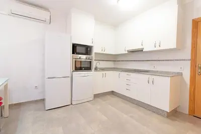 a kitchen with white appliances and white cabinets at Global Vacacional, Apartamento 2 dormitorios en Canet d'en Berenguer in Canet de Berenguer