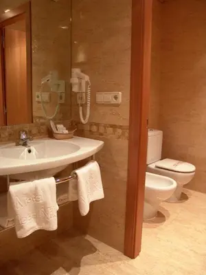 a bathroom with a sink and a toilet and a phone at Valle del Nilo in Ventas de Poyo