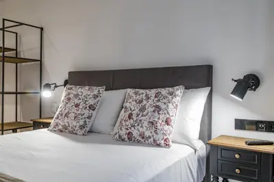 a bedroom with a white bed with two pillows at Goerlich by Alma Suites in Valencia