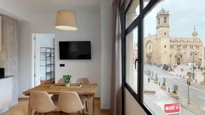 a dining room with a table and a large window at Goerlich by Alma Suites in Valencia