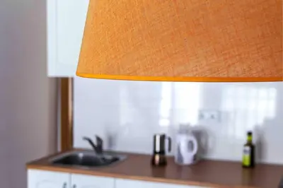 a kitchen counter with a sink and a lamp at Acogedor Dúplex con terraza interior en la playa in Valencia