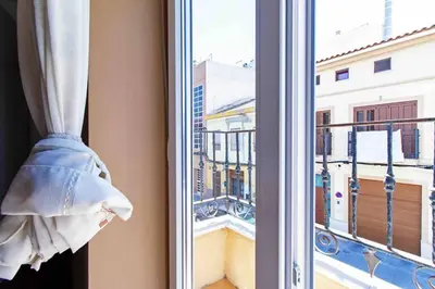 a window with a view of a city at Acogedor Dúplex con terraza interior en la playa in Valencia