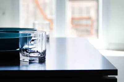 a glass sitting on top of a table at Estudio para parejas con terraza en la playa in Valencia