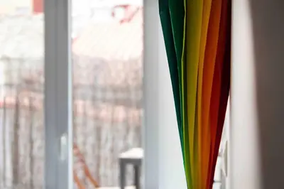 a group of colorful umbrellas next to a window at Estudio para parejas con terraza en la playa in Valencia