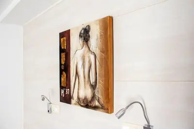 a painting of a woman hanging on a wall at Apartamento con terraza privada cerca de la playa in Valencia