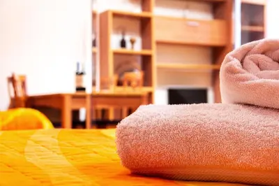 a stack of towels sitting on top of a table at Estudio para parejas con WIFI en la playa in Valencia