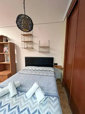 a bedroom with a bed with two pillows on it at Estudio para parejas con WIFI en la playa in Valencia