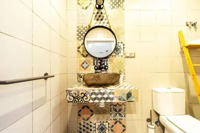 a bathroom with a mirror and a sink at Chic y renovado loft en la playa in Valencia