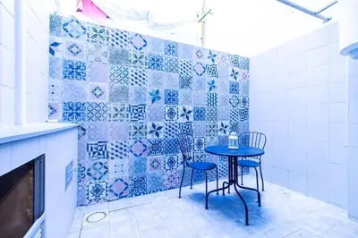 a table and chairs in a kitchen with blue tiles at Chic y renovado loft en la playa in Valencia
