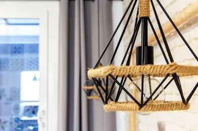 a hanging chandelier with rope and a window at Chic y renovado loft en la playa in Valencia