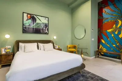 a bedroom with a large bed and a painting on the wall at AmazINN Collection Valencia Centro EVI in Valencia