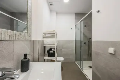 a bathroom with a bath tub with two potted plants at AmazINN Collection Valencia Centro EVI in Valencia