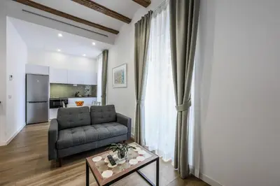 a bedroom with a bed and a tv and a table at AmazINN Collection Valencia Centro EVI in Valencia