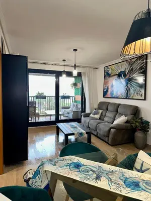 a hotel room with two beds and a flat screen tv at Marin Beach Apartments Patacona in Valencia