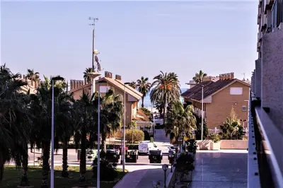 a playground with benches and play equipment in front of a building at Marin Beach Apartments Patacona in Valencia