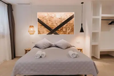 a bedroom with a bed with two towels on it at Hulot B&B Valencia in Valencia