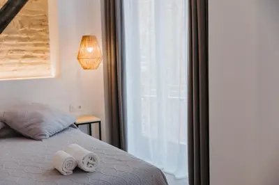 a bedroom with a bed with two towels on it at Hulot B&B Valencia in Valencia