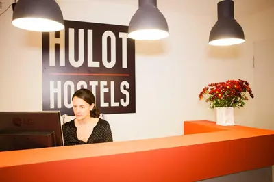 a woman sitting at a desk in front of a computer at Hulot B&B Valencia in Valencia
