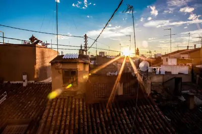 an image of the sun setting over a rooftop at Hulot B&B Valencia in Valencia