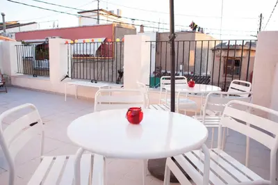 two white tables and white chairs on a balcony at Hulot B&B Valencia in Valencia