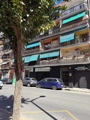 a street with cars parked in front of a building at Cosy flat with excellent location in Valencia! in Valencia