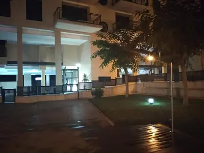 an empty parking lot in front of a building at night at Apartamento Moncofar playa in Moncófar