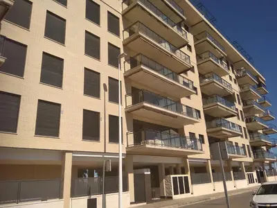 an apartment building with a car parked in front of it at Apartamento Moncofar playa in Moncófar
