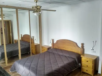 a bedroom with a bed and two mirrors at Casa Blanca in Algimia de Alfara