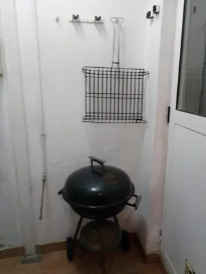 a black wok sitting on a wheelbarrow in a room at Casa Blanca in Algimia de Alfara