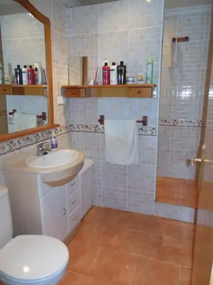 a bathroom with a toilet and a sink and a shower at Casa Blanca in Algimia de Alfara