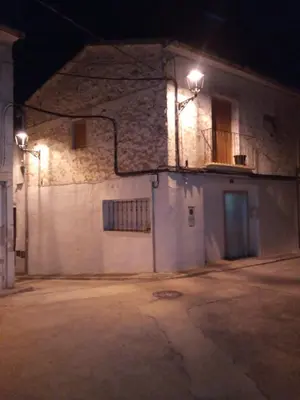 a building with two lights on the side of it at night at Casa Blanca in Algimia de Alfara