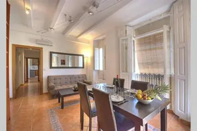 a living room with a table and a couch at Main Central Station Apartment in Valencia
