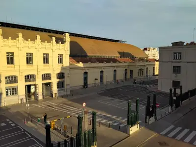 an empty parking lot in front of a building at Main Central Station Apartment in Valencia