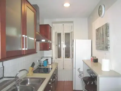 a kitchen with a sink and a refrigerator at Main Central Station Apartment in Valencia
