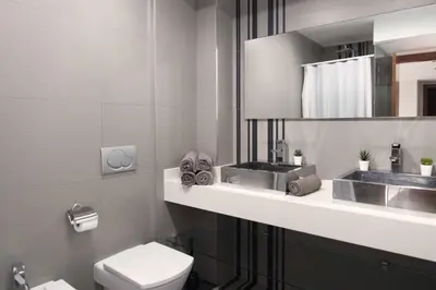 a bathroom with a toilet and a sink at Apartamentos turísticos Cullera in Faro de Cullera