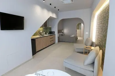a living room with a couch and a tv at Renovado Estudio privado en la playa in Valencia
