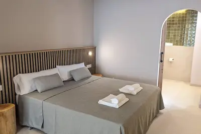 a bedroom with a bed with two towels on it at Renovado Estudio privado en la playa in Valencia