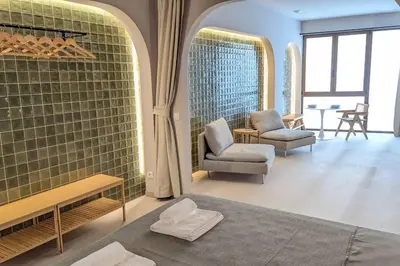 a living room with two chairs and a couch at Renovado Estudio privado en la playa in Valencia