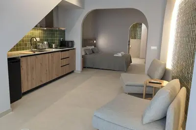 a kitchen and living room with a couch and a bed at Renovado Estudio privado en la playa in Valencia