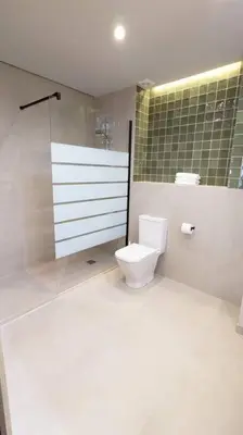 a bathroom with a toilet and a glass shower at Renovado Estudio privado en la playa in Valencia
