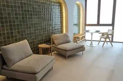 a room with two chairs and a chair and a table at Renovado Estudio privado en la playa in Valencia