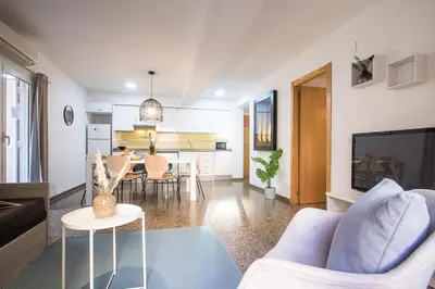 a living room with a couch and a dining room at Apartamentos Carmen in Valencia
