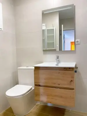 a bathroom with a toilet and a sink and a mirror at Renovado y sofisticado en el centro de Valencia in Valencia