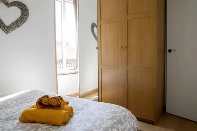 a bedroom with a bed with a yellow towel at Renovado y sofisticado en el centro de Valencia in Valencia